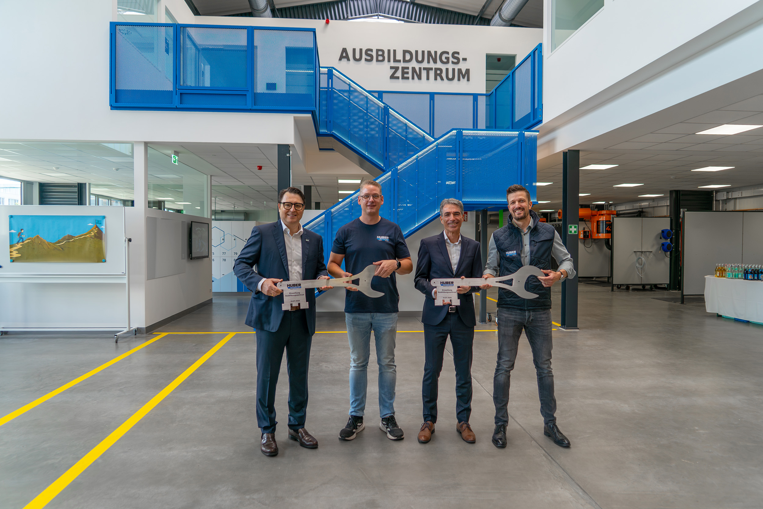 The symbolic handover of the key to the new training centre was performed by (from left to right): Dr Oliver Rong (Vice CEO and Chief Technical & Production Officer), Sebastian Daum (Training Manager), Michael Hiller (Head of Human Resources), and Michael Plank (Head of Site Development)